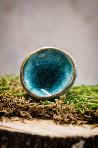Ceramic knob turquoise blue with gold trim.